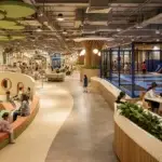 Modern family entertainment center combining a trampoline zone, toddler play, role play, cafe, and party rooms