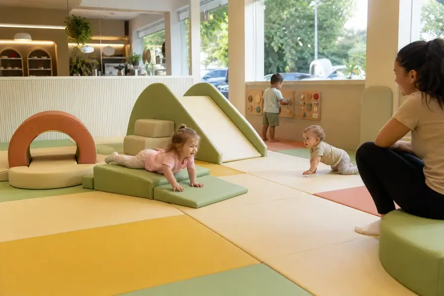 Toddler soft-play area with foam-padded floor and low-height equipment