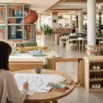 Independent play cafe founder reviewing a welcoming commercial play cafe with clear parent sightlines