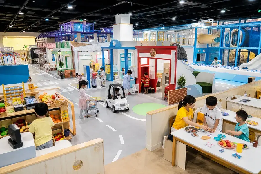 Mini city role play indoor playground with storefronts and activity zones for 2026 family entertainment trends