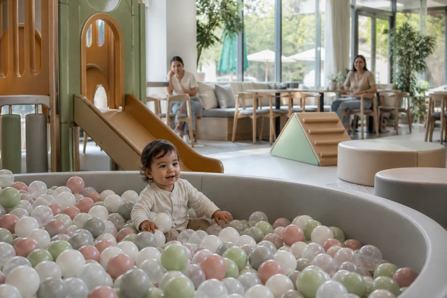 Toddler ball pit and soft play zone with parent sightlines in a play cafe.