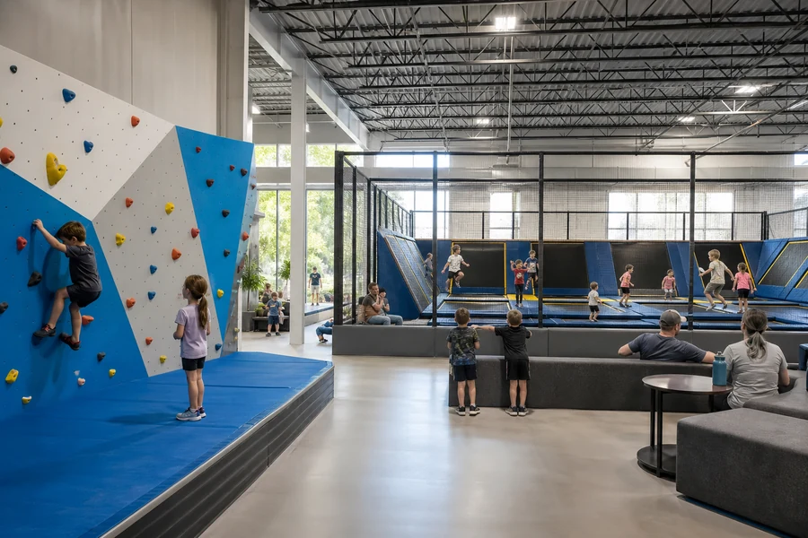 Climbing wall and trampoline zones planned within a family entertainment center.