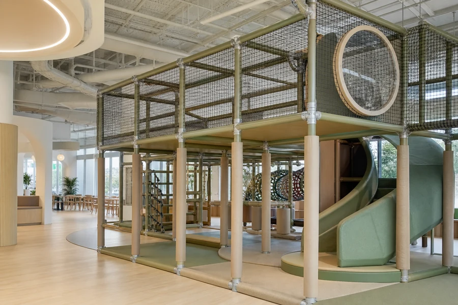 Galvanized steel playground frame with powder-coated joints in a commercial indoor play structure.